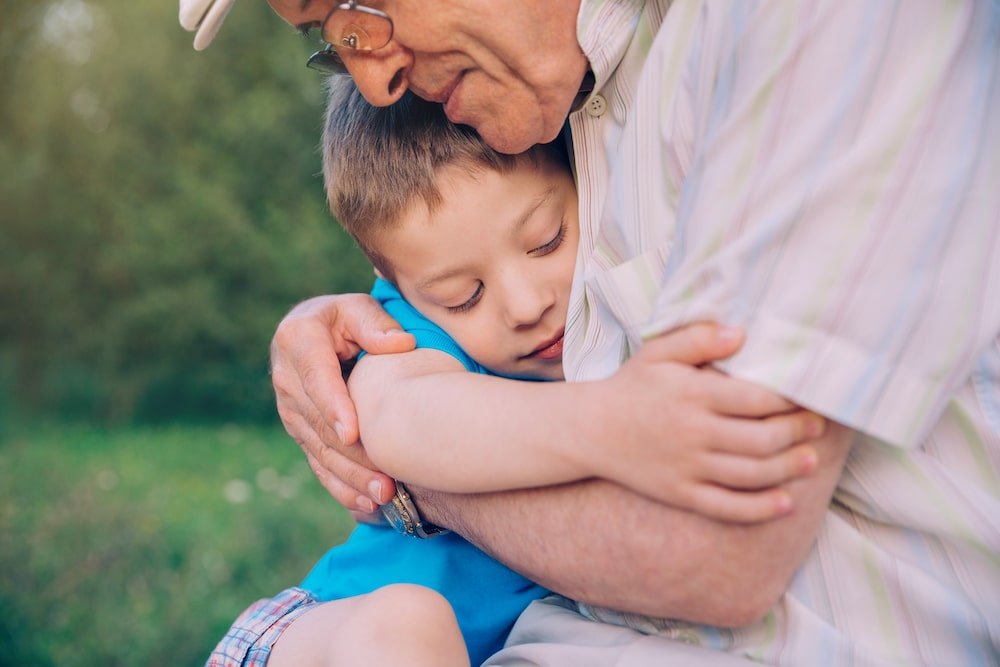 grandpa hugging his grandson